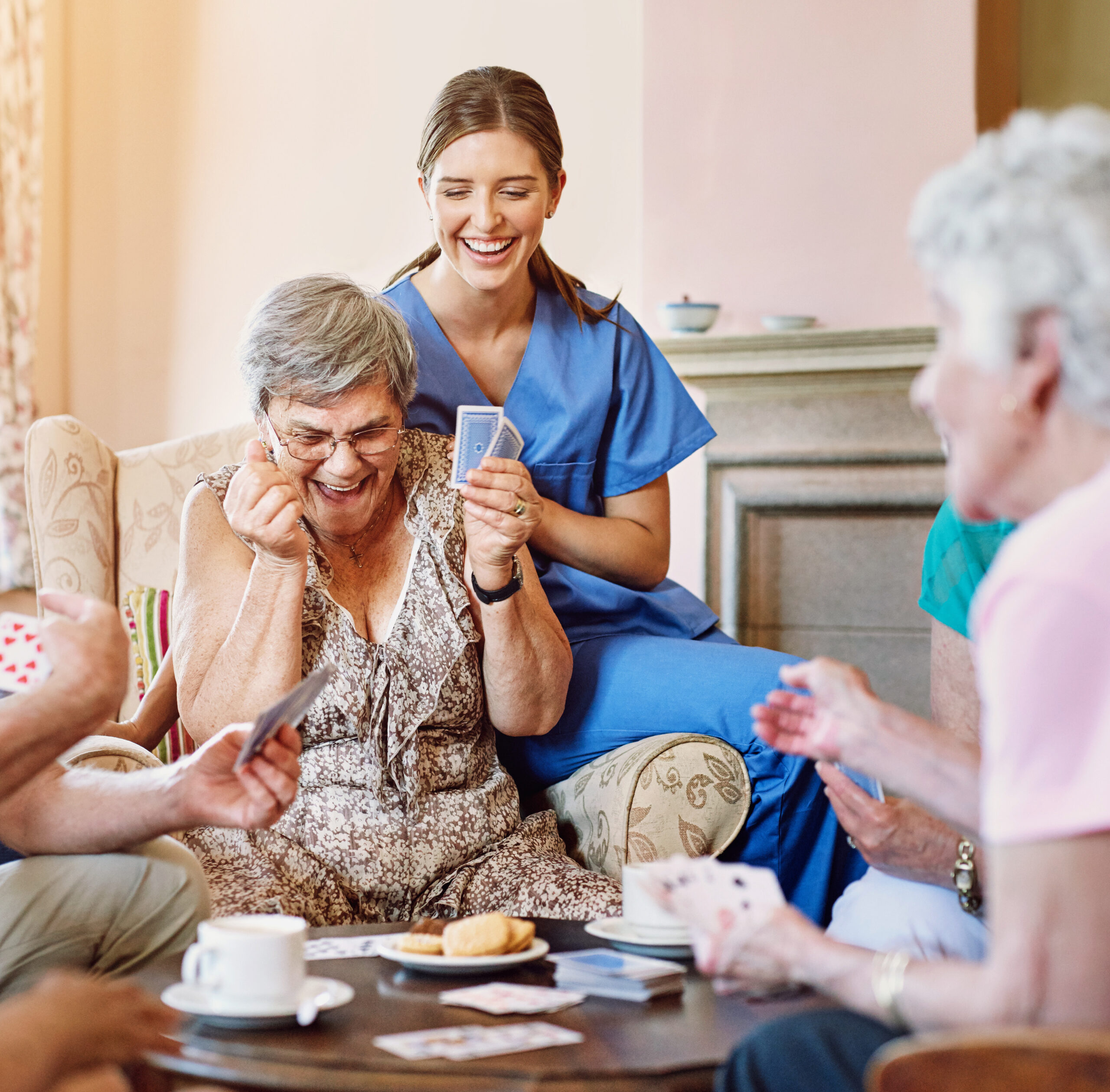 Senior woman, happy and card game win in retirement home with friends or roommates for recreational fun. Nurse, victory and success in rummy or casino games with biscuits, excitement and smile. Senior woman, happy and card game win