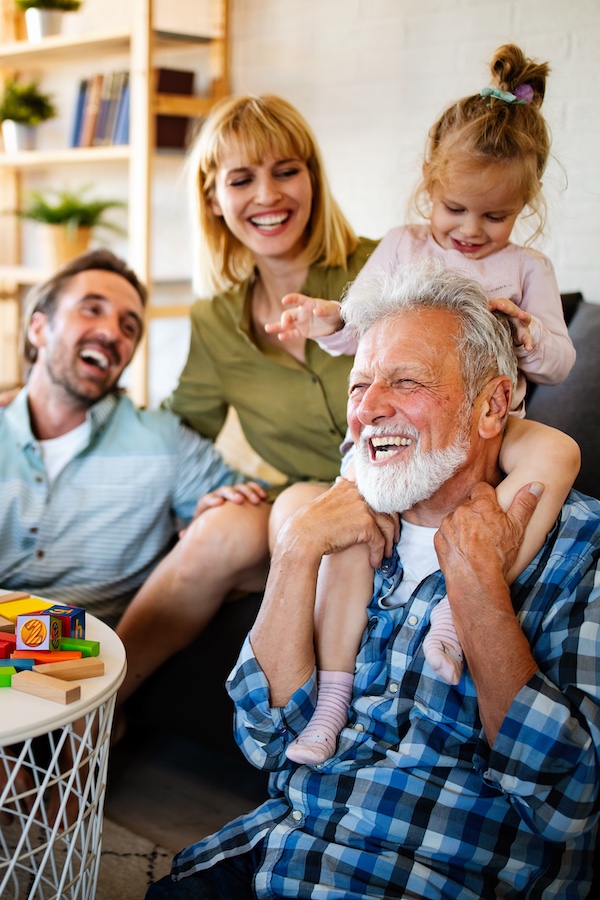 Mature grandparents playing with grandchildren and having fun with family Mature grandparents playing with grandchildren and having fun with family